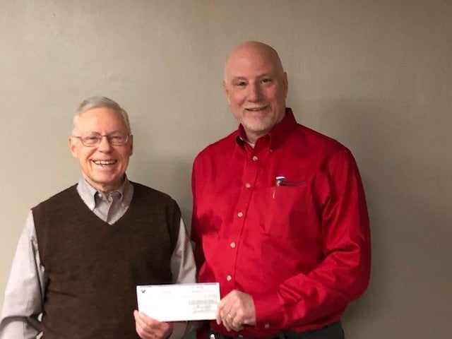 Dave Burtch with Paulding County accepts check from PPEC CEO George Carter for economic development
