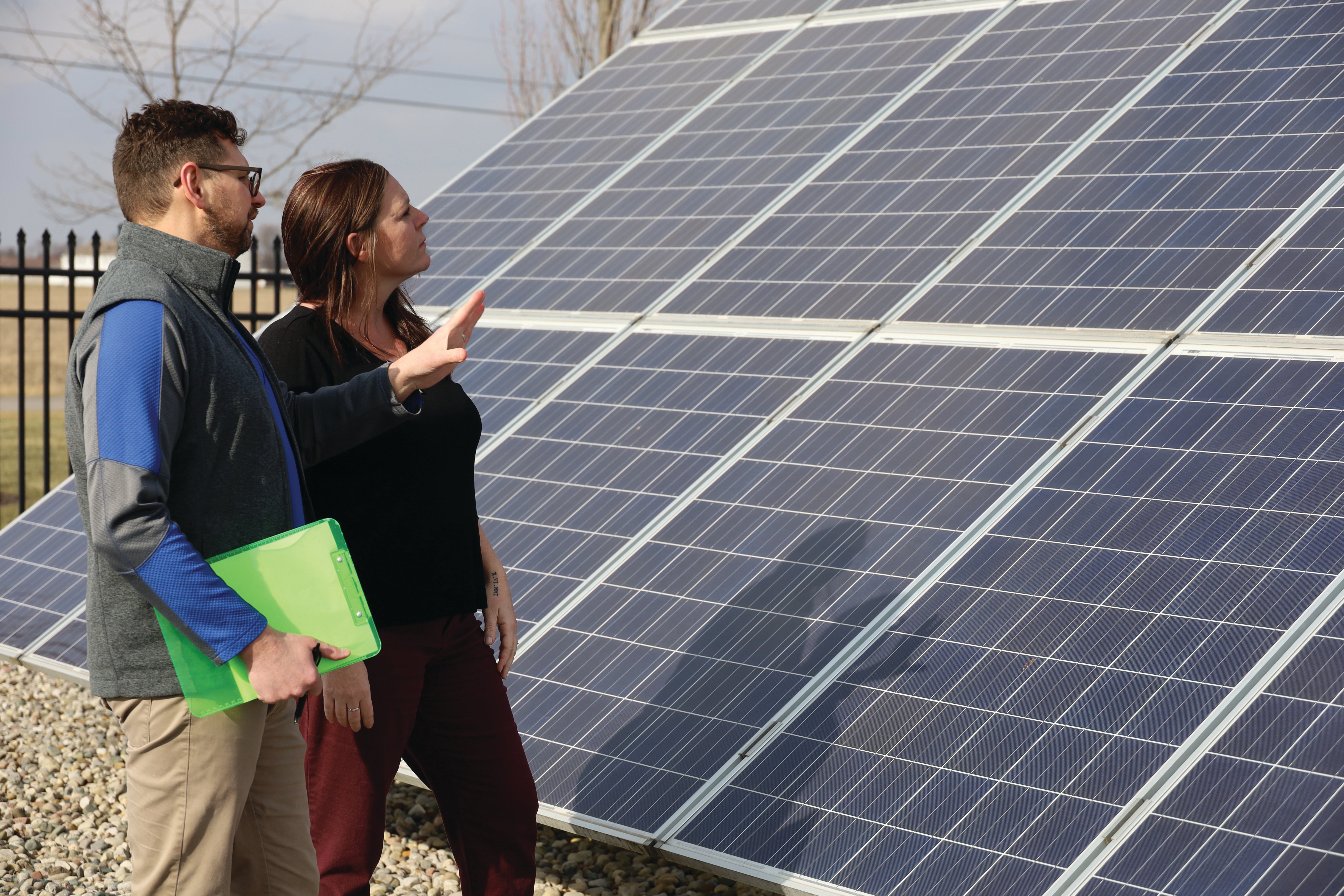 Peter Niagu and Kathy Kuckuck standing with a solar panel.