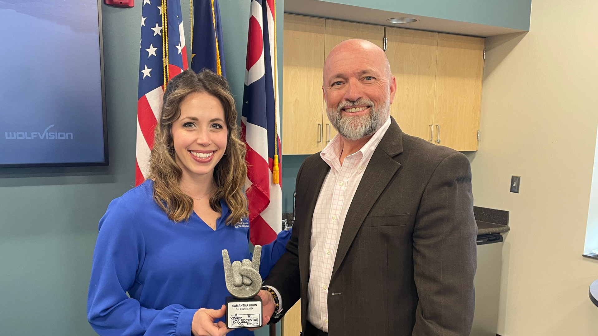 CEO Randy Price presents the Rockstar Award to Samantha Kuhn