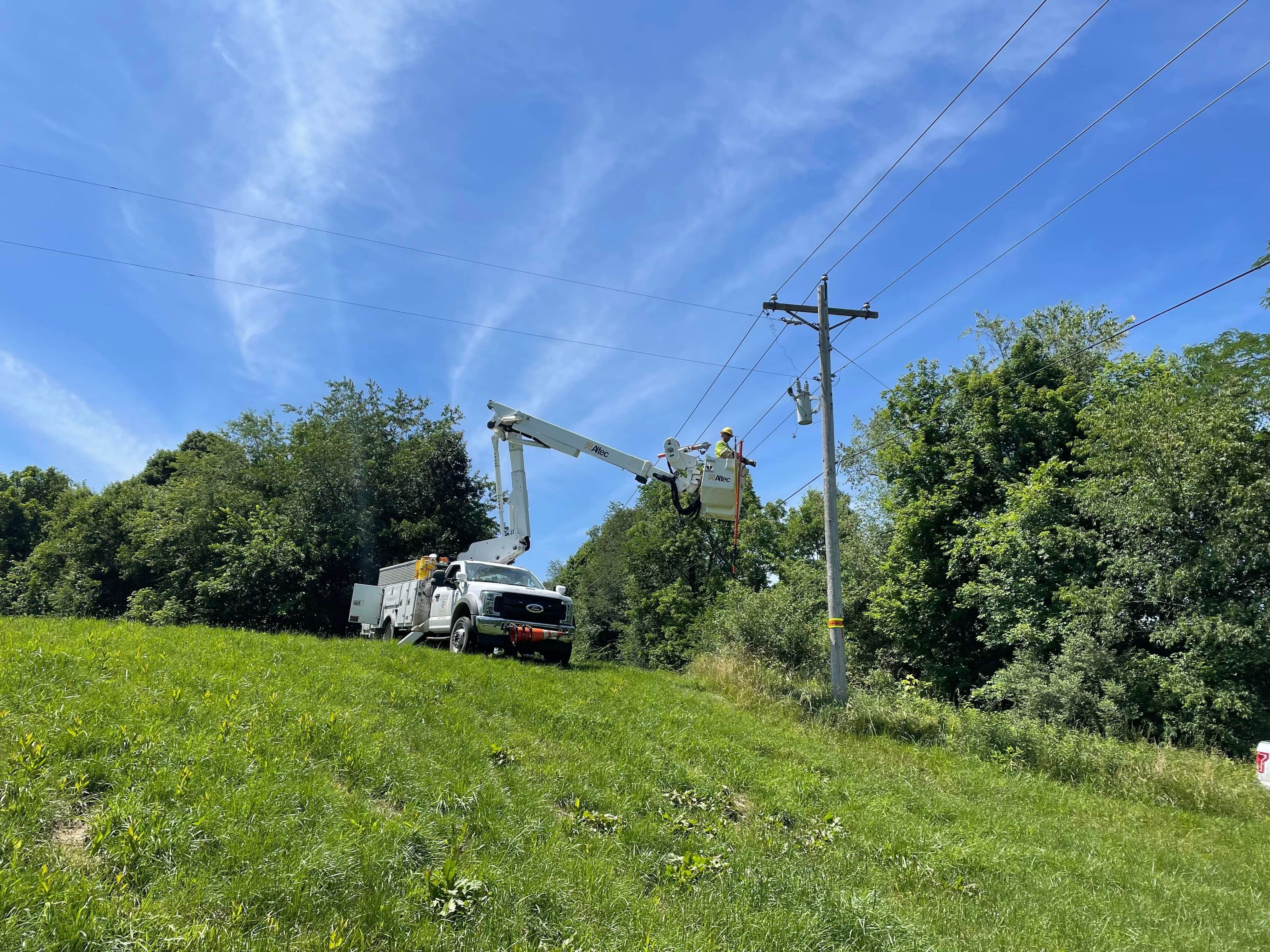 bucket truck in field restoring power