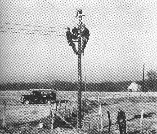 Men on power lines_historic photo.jpg
